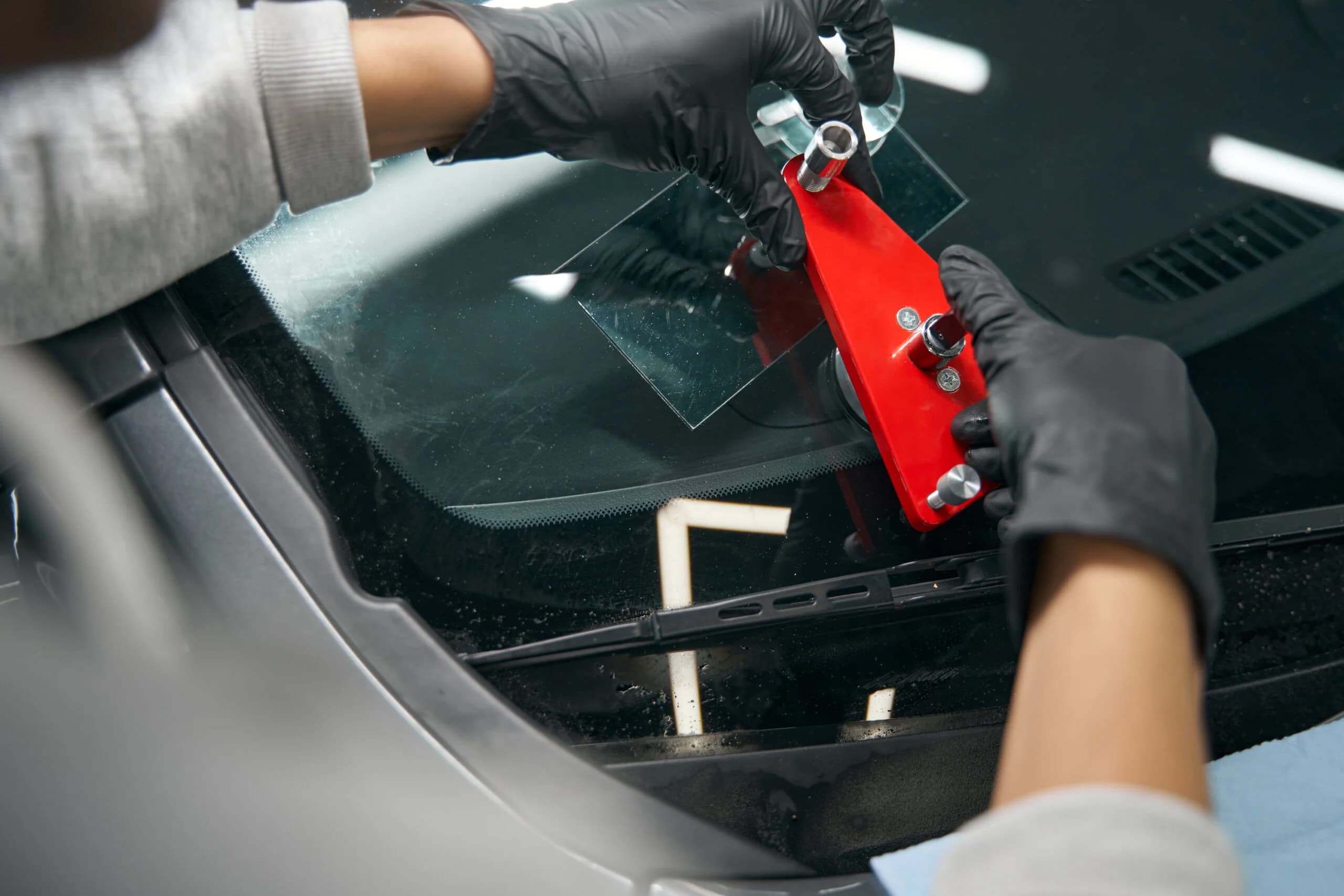 Auto glass technician working on windshield