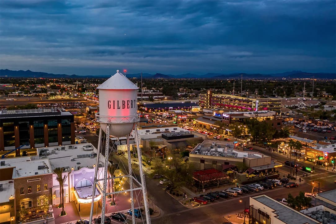 Gilbert cityscape at night with the Gilbert Water Tower in the foreground